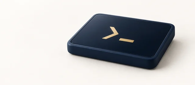 A matte navy slab with a dark glass face showing one large gold prompt chevron and cursor, on warm paper.