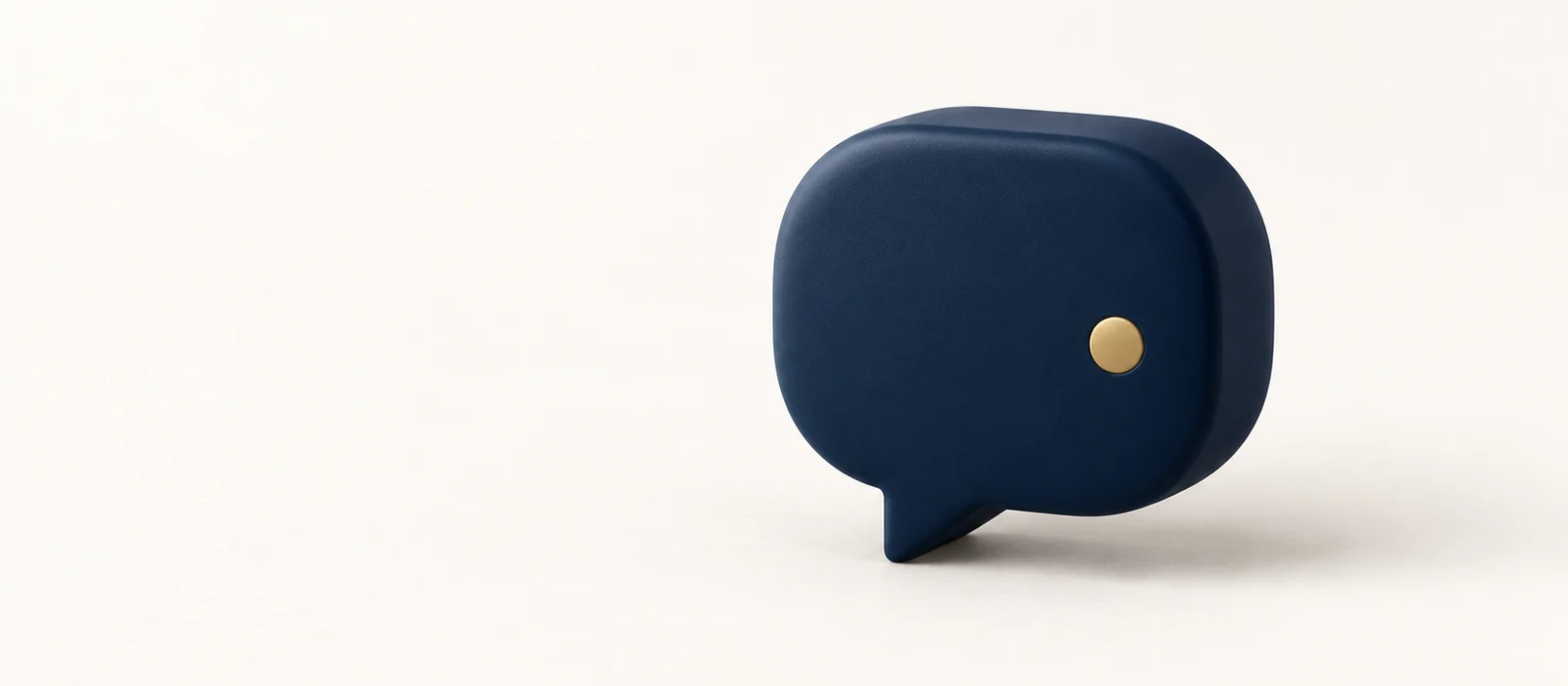 A solid matte navy speech bubble with a single gold dot, on warm paper.