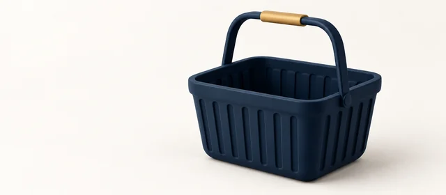 A matte navy shopping basket with a gold handle grip, on warm paper.