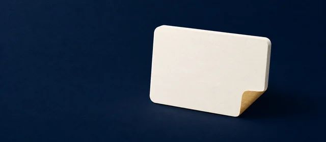 A paper-white card with a gold folded corner on deep navy.